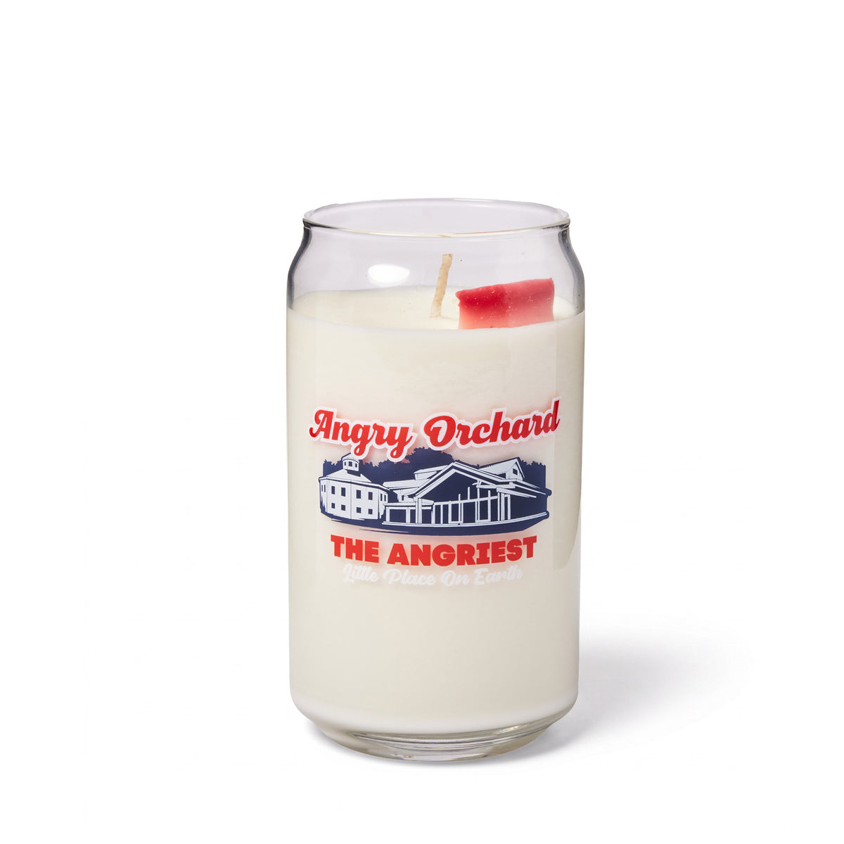 A clear glass jar candle with white wax and a red wick, printed with a navy blue building illustration and red text reading 'Angry Orchard' and 'THE ANGRIEST Little Place on Earth', on a white background.