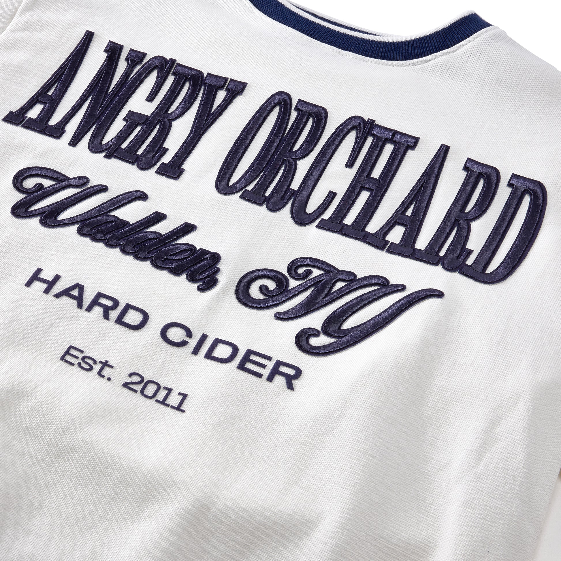 Close‑up of the Angry Orchard White Walden Crew Sweatshirt fabric—soft white knit texture highlighting quality material and craftsmanship of the crewneck sweatshirt