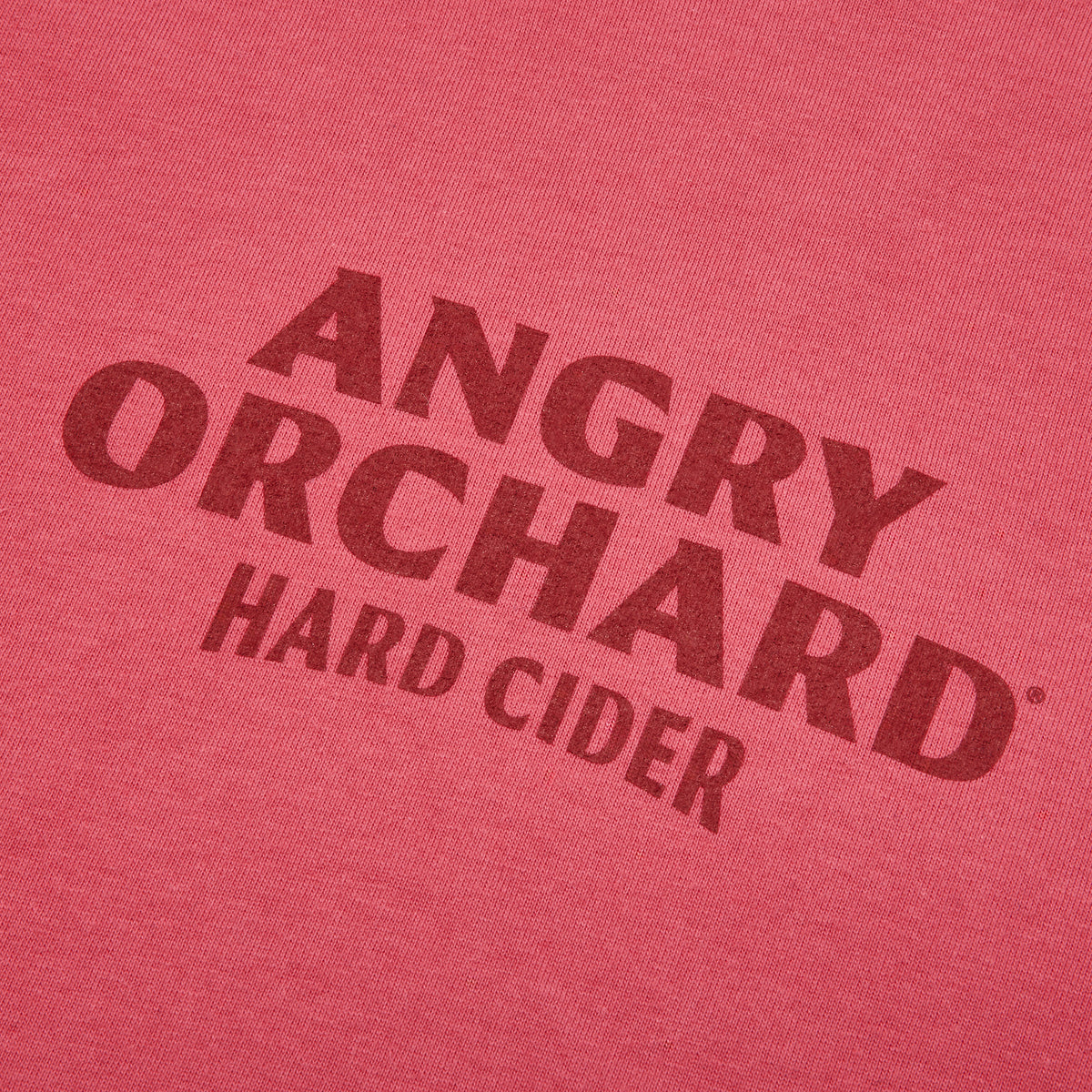 Red women's tee shirt with a dark red logo on the front chest that says ANGRY ORCHARD HARD CIDER 