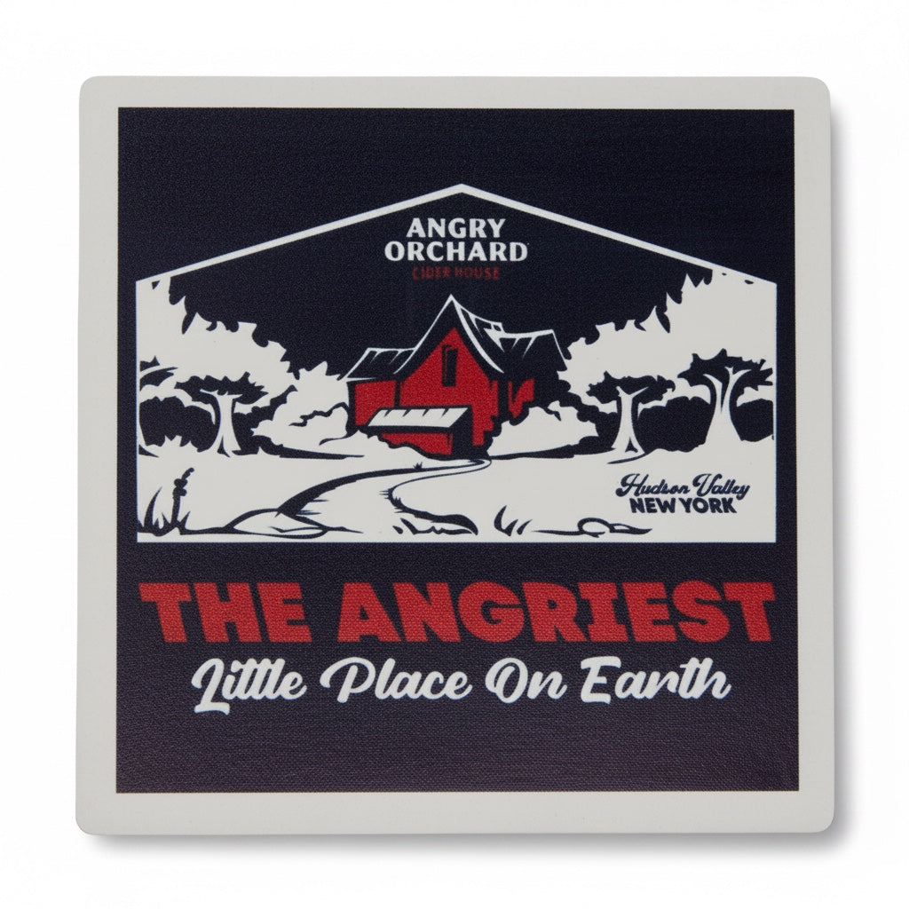 A square coaster with rounded corners featuring a vintage-style graphic of an angry orchard scene. The design has a dark navy blue background with a red barn, white trees, and bold red and white text reading 'ANGRIEST Little Place On Earth' and 'Hudson Valley New York'.