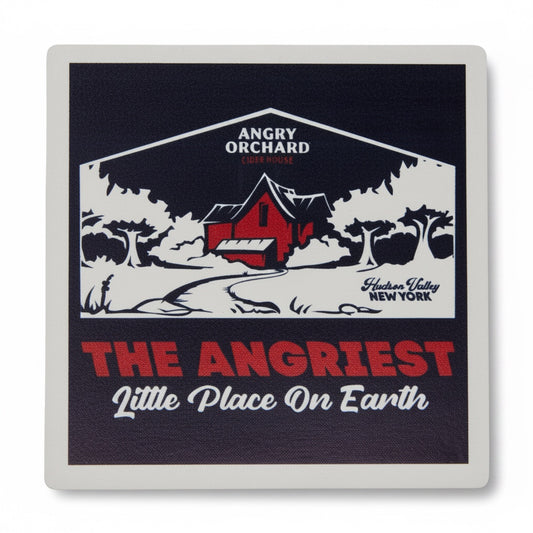 A square coaster with rounded corners featuring a vintage-style graphic of an angry orchard scene. The design has a dark navy blue background with a red barn, white trees, and bold red and white text reading 'ANGRIEST Little Place On Earth' and 'Hudson Valley New York'.
