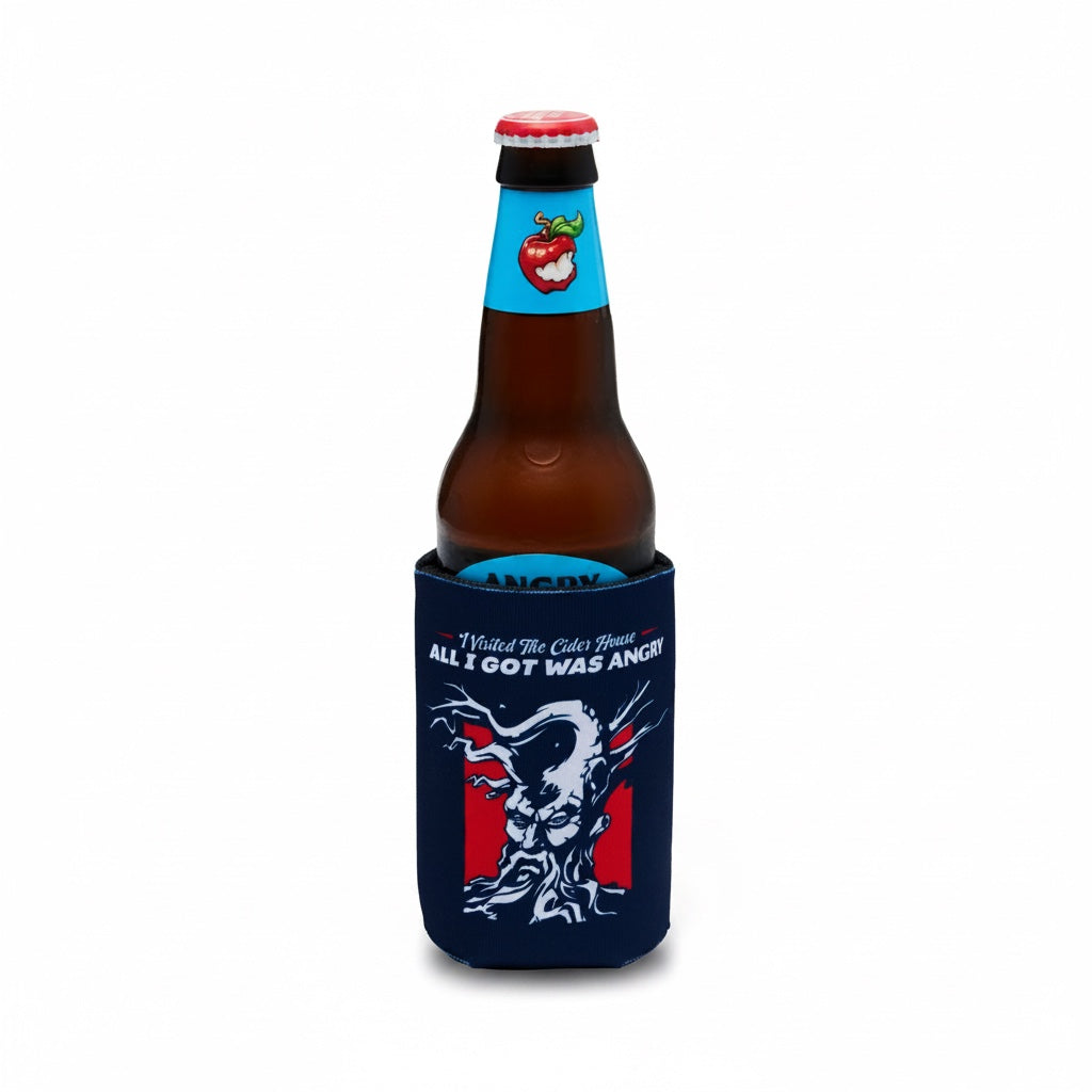 A brown glass beer bottle with a red cap, snugly fitted in a navy blue neoprene can cooler. The cooler features a white tree graphic and the text 'All I GOT WAS ANGRY!'.