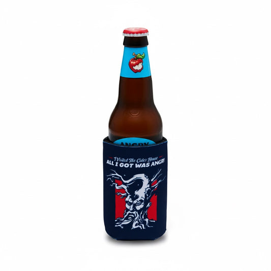A brown glass beer bottle with a red cap, snugly fitted in a navy blue neoprene can cooler. The cooler features a white tree graphic and the text 'All I GOT WAS ANGRY!'.