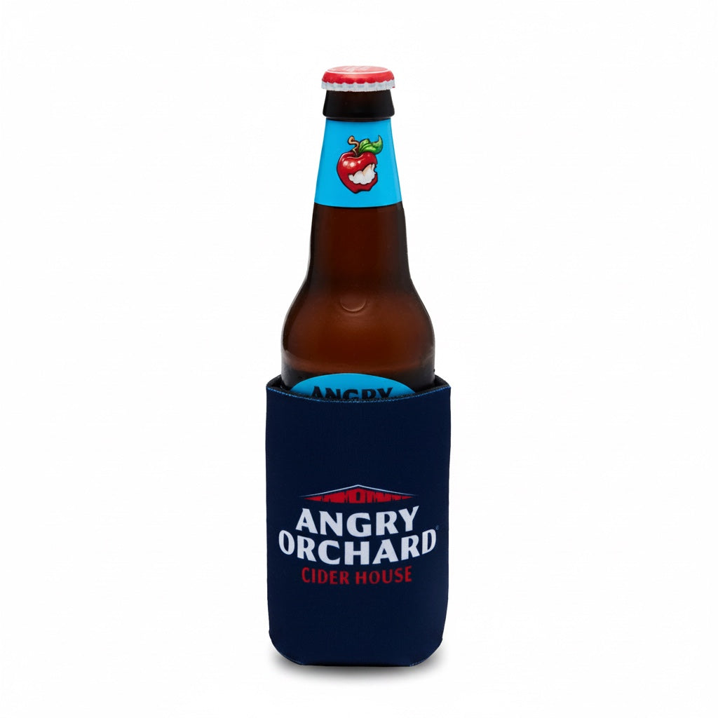 A brown glass beer bottle with a red cap and a blue neck label, snugly fitted inside a navy blue neoprene bottle sleeve printed with the Angry Orchard Cider House logo, on a white background.