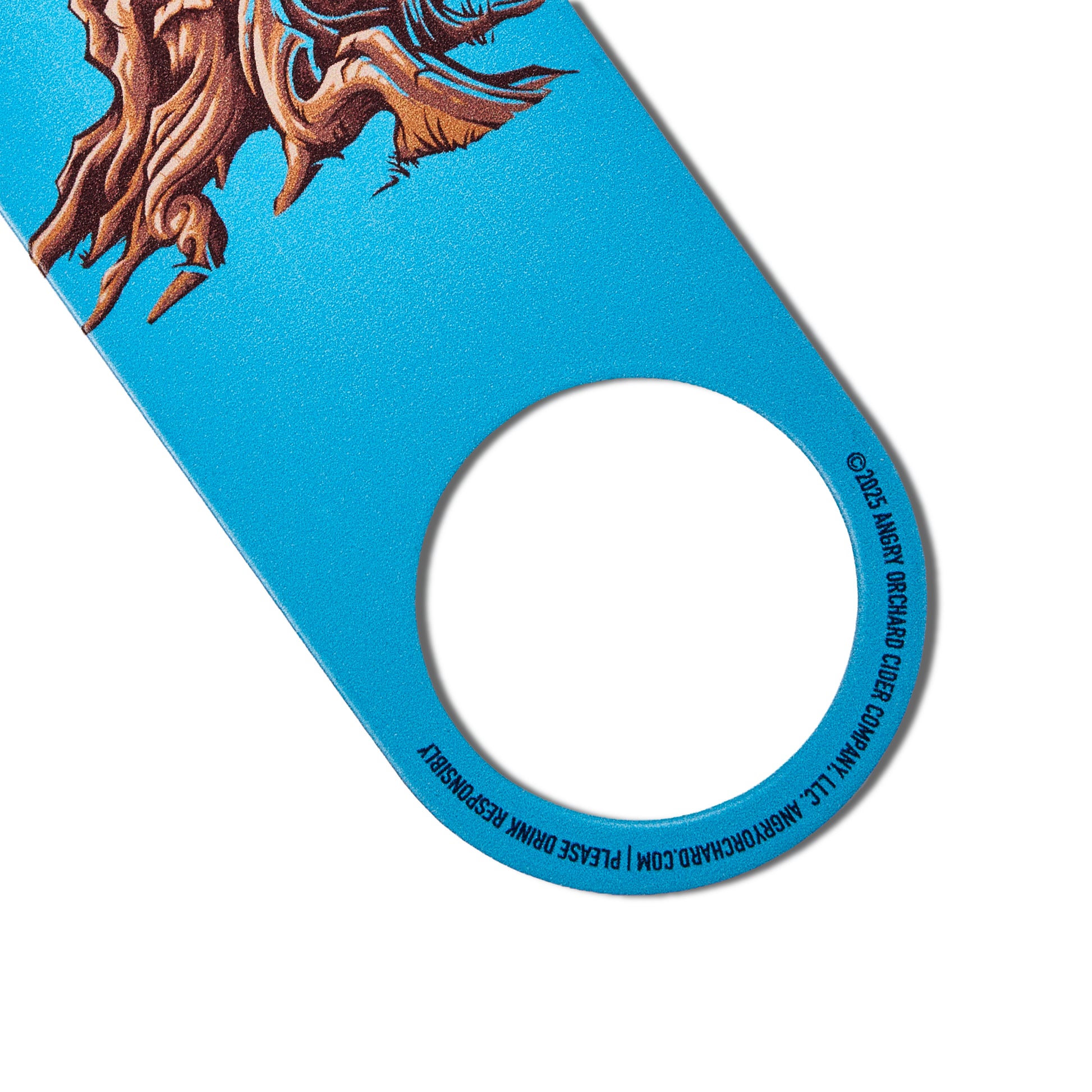 A close-up of a bright blue bottle opener with a circular hole, featuring an illustrated brown tree trunk and branches at the top and black printed text around the hole.