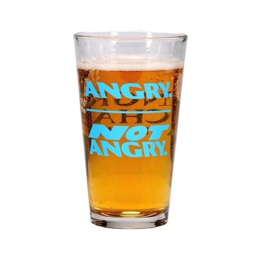 On one side of this glass is the writing "Angry." with a line under then "Not Angry." On the other side of the glass is the writing "Angry Orchard Hard Cider". All writing is in blue.