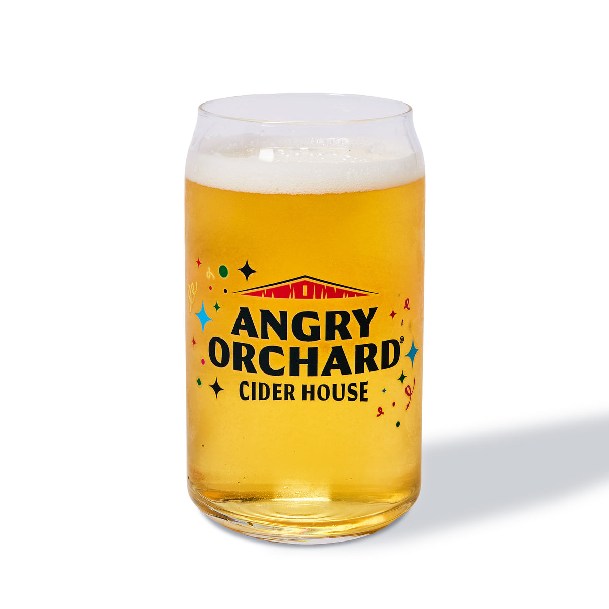 A clear glass can-shaped tumbler filled with golden beer and topped with white foam, printed with the Angry Orchard Cider House logo in black, red, and multicolor accents on the front, photographed on a clean white background.