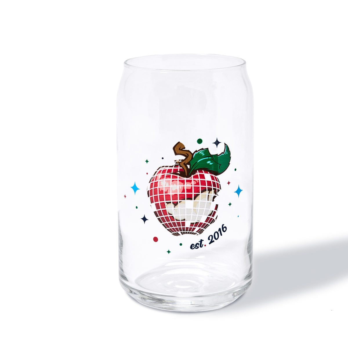 A clear glass can-shaped tumbler with a colorful printed design of a red-and-white disco-ball apple with a green leaf and the text 'est. 2016', shown on a white background.