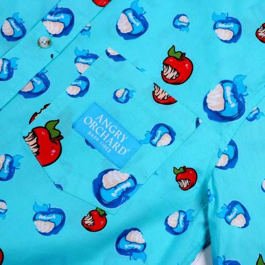 Close-up of the pocket on the left side of the chest which has a blue patch on it that says, "Angry Orchard Hard Cider".