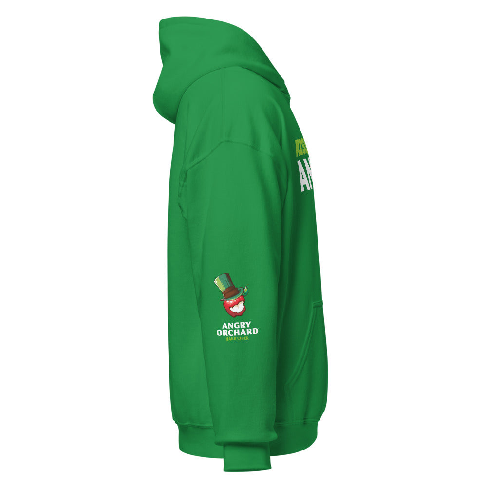 Right side of Kiss Me, I'm Angry Hoodie in Shamrock Green. Right sleeve shows a small design featuring a red angry orchard apple with a shamrock-colored top hat. Beneath the design is "Angry Orchard" in white text, followed by "Hard Cider" in smaller lime green text.